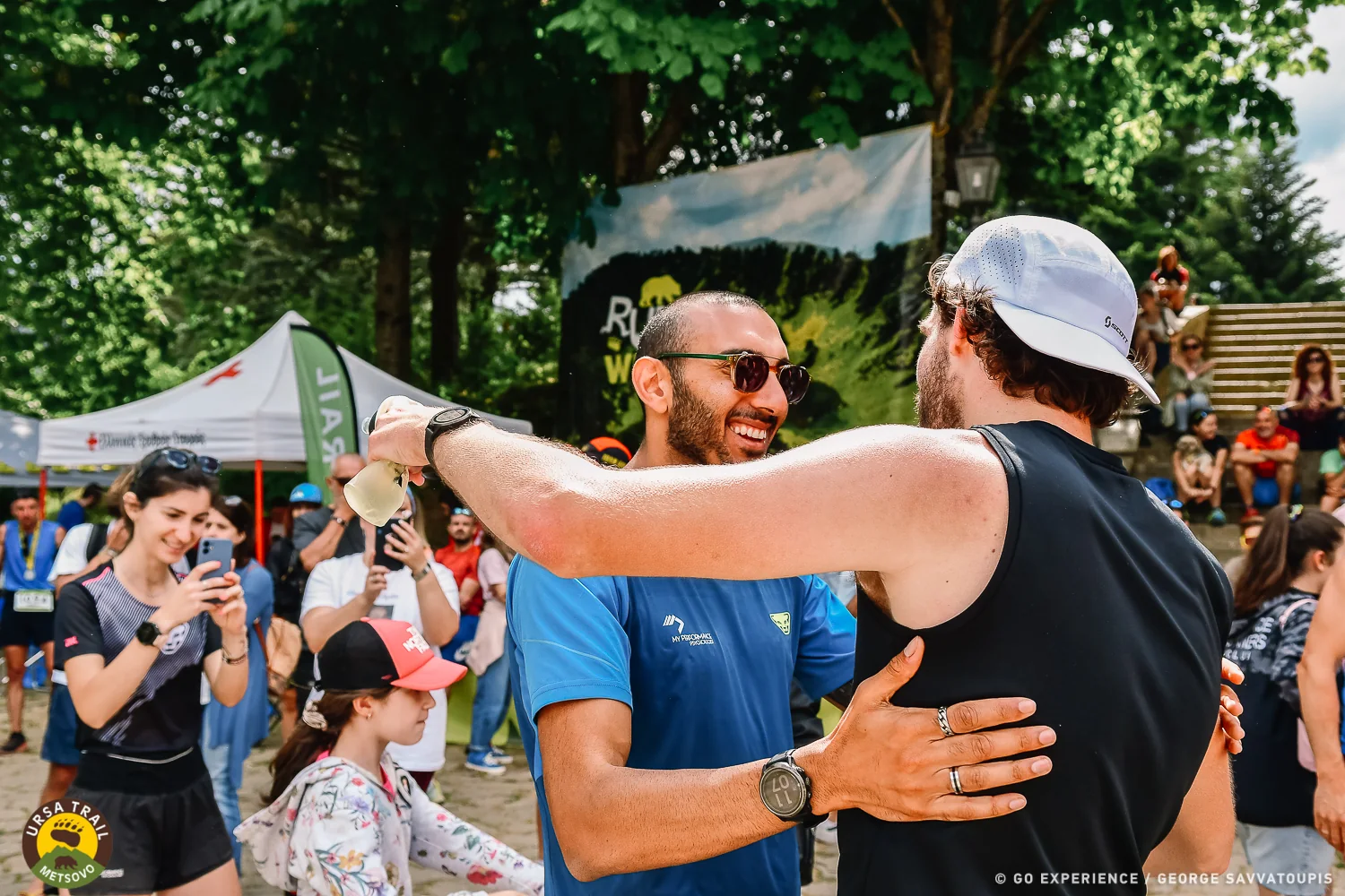 Karim greeting an athlete at the finish line